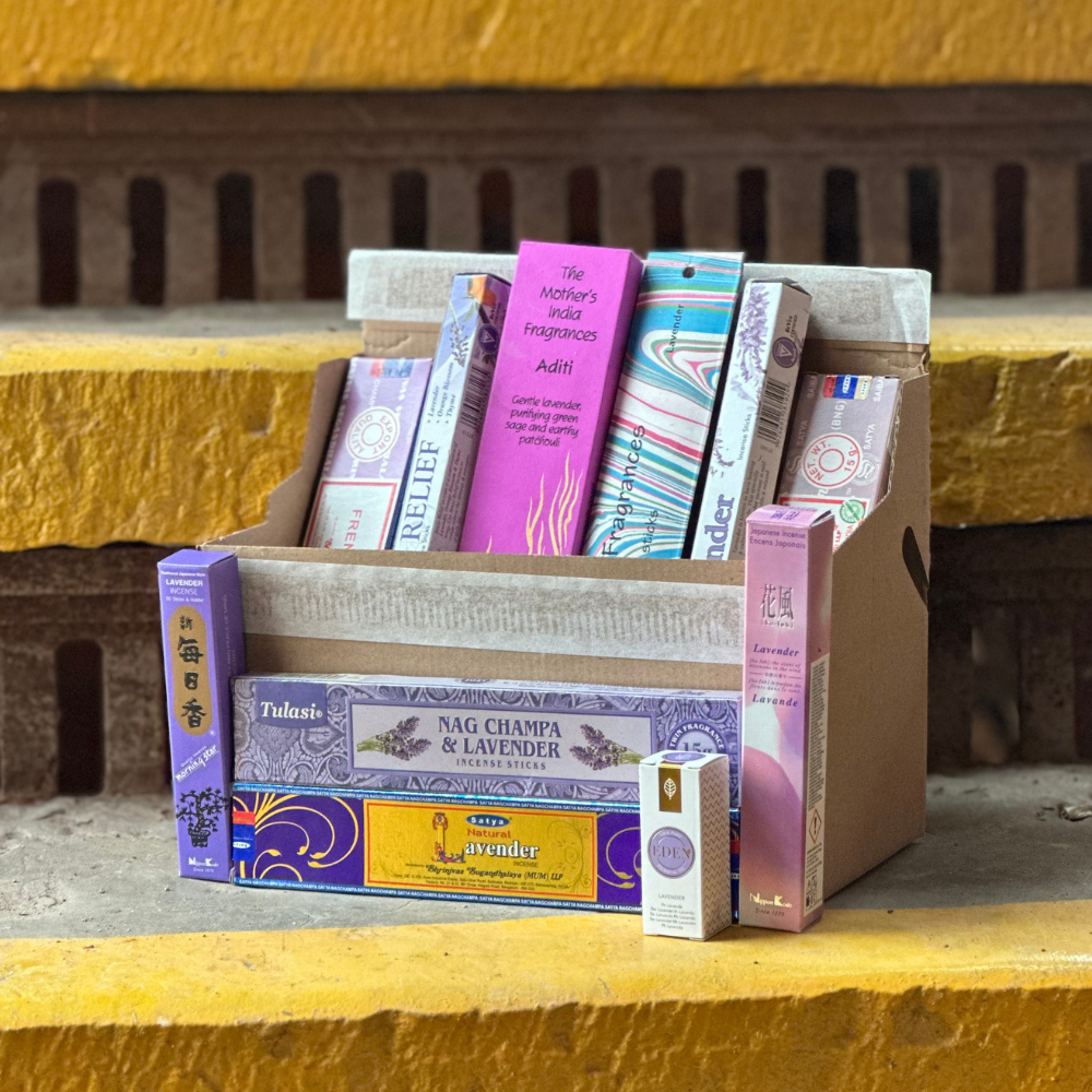Collection of incense boxes on a yellow surface with a rustic background